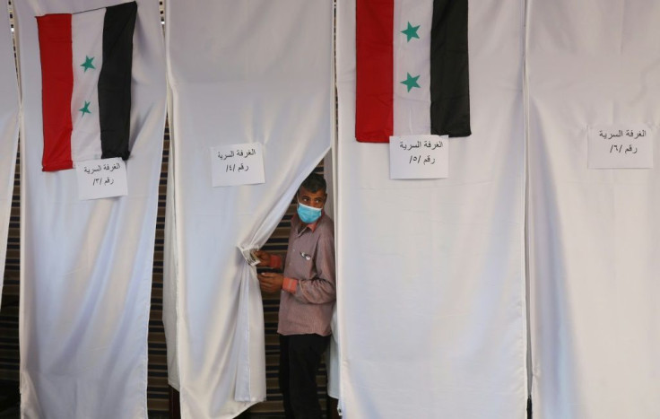 A Syrian voter in Lebanon casts his ballot on May 20, ahead of the main day of voting on Wednesday