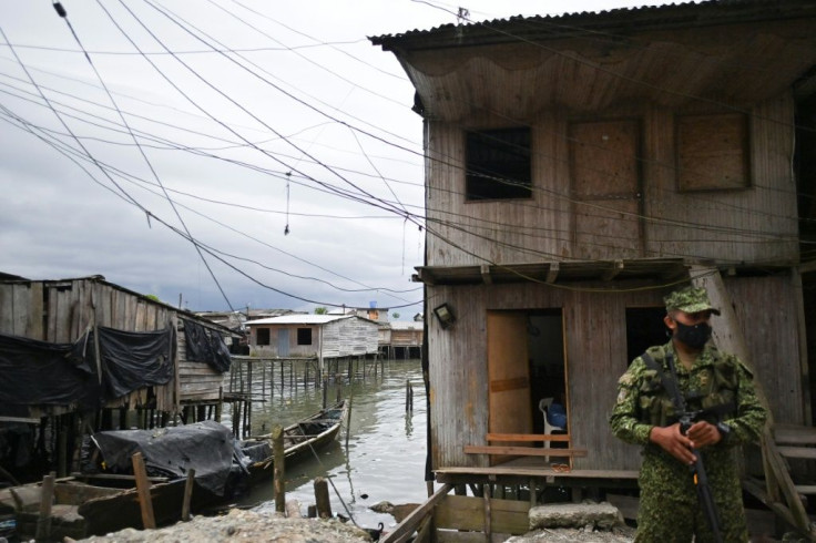 Security forces guard the Nayero bridge in La Playita where 2,000 Afro-Colombian inhabitants live in fear for their lives