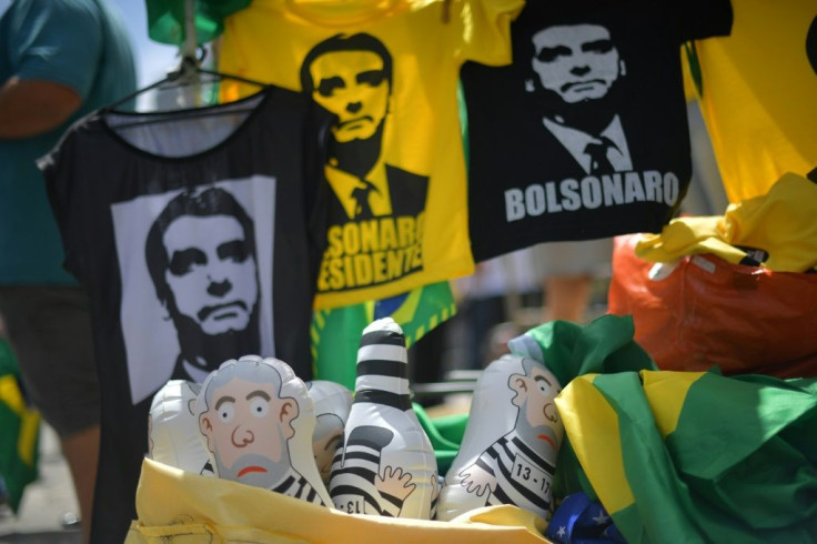 T-Shirts with the image of Jair Bolsonaro are pictured in 2018 next to inflatable dolls representing Lula, who has wasted no time in attacking his rival