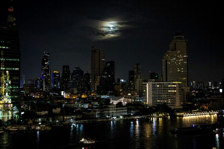 The 'Super Blood Moon' peeks through clouds in Hong Kong Wednesday