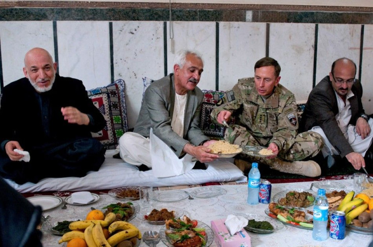 U.S. Army Gen. David H. Petraeus and Afghan President Hamid Karzai share lunch during a visit to Zaranj