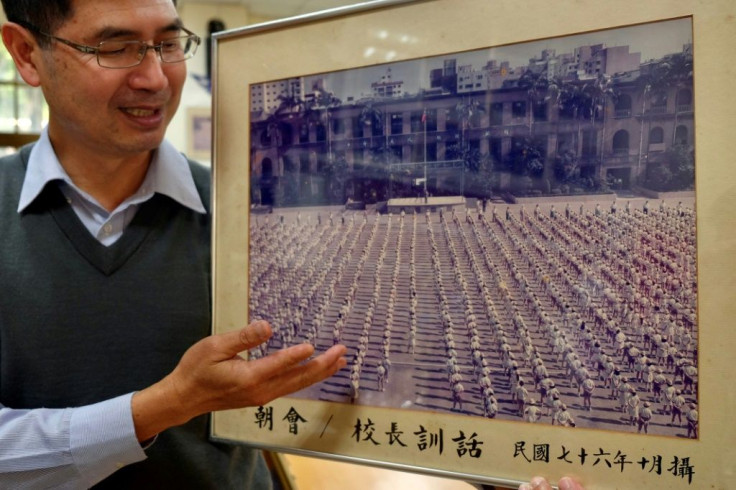 Lin Ming-ju, principal of Taipei's Laosong Elementary School, shows a photograph taken in 1987 showing students at the school stadium