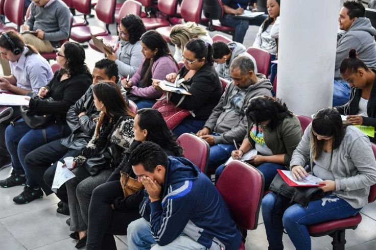In this file photo taken on June 28, 2019, unemployed people look for job opportunities at a governmental workers service department in Sao Paulo, Brazil