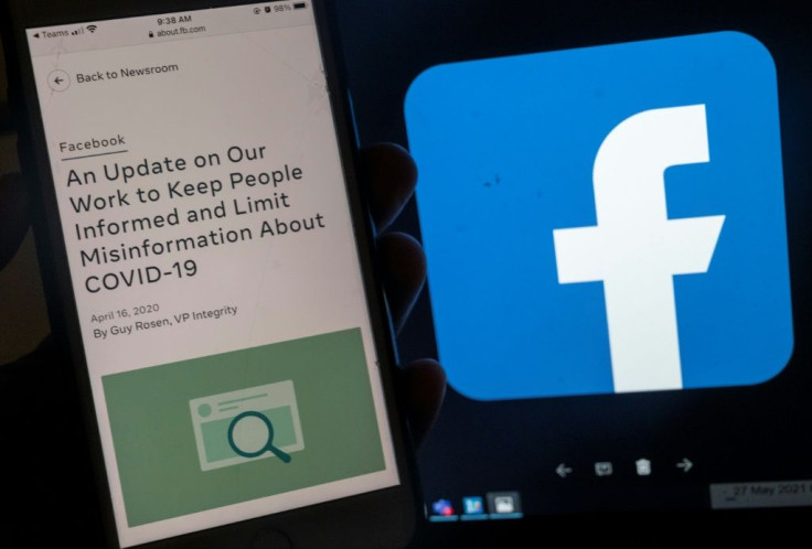 In this photo illustration, a smartphone screen displays a new policy on Covid-19 misinformation with a Facebook website in the background, on May 27, 2021