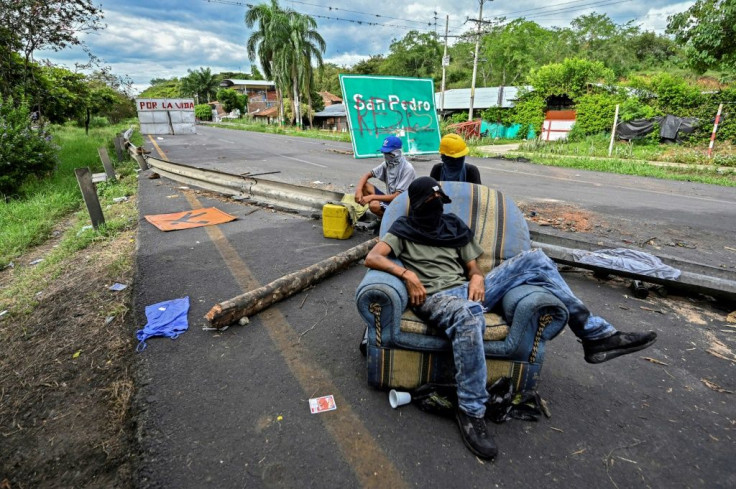 Demonstrators block the Panamerican highway between Buga and Cali as part of their protest against the government of Colombian President Ivan Duque on May 26, 2021