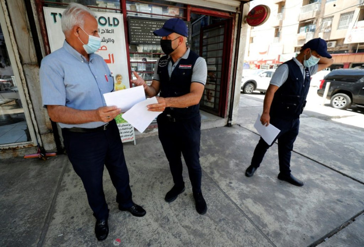 Members of the Iraqi Interior Ministry's anti-"fake news" team hand out leaflets on identifying misinformation in the capital Baghdad