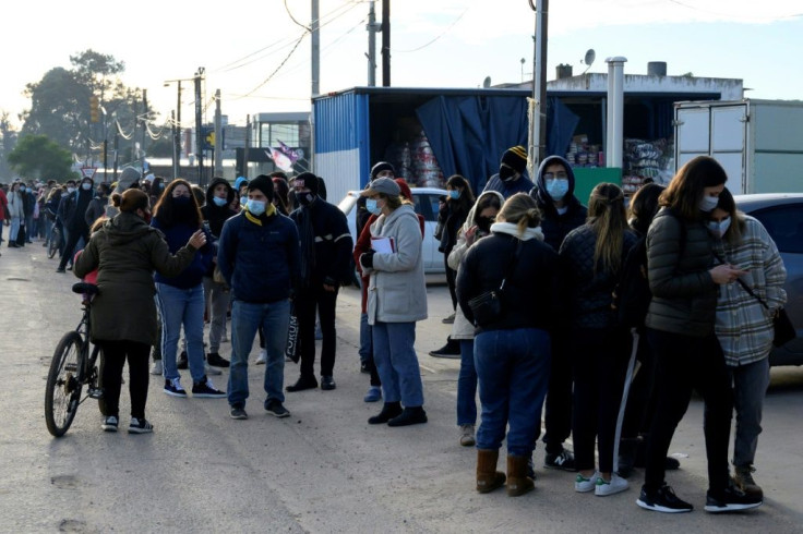 People queue to get a Covid-19 vaccination appointment in Paso de Carrasco, Uruguay on May 26, 2021