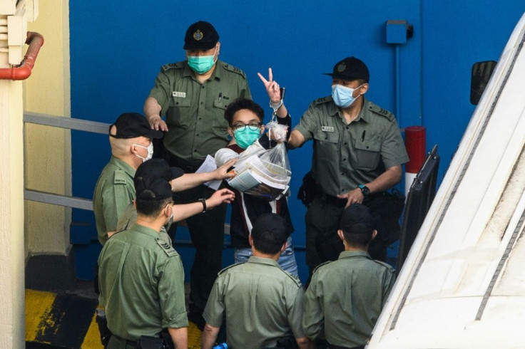 Figo Chan (C) is one of eight Hong Kong activists jailed on Friday for taking part in 2019's huge pro-democracy protests, the latest in a long line of democracy figures now behind bars