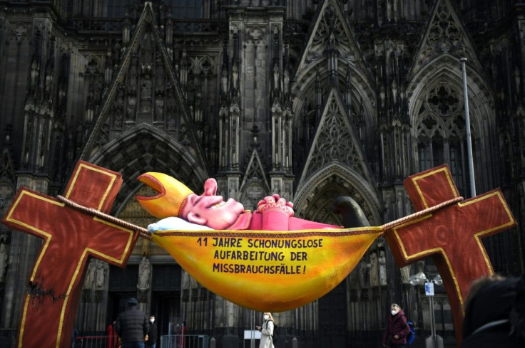This work by artist Jacques Tilly carries the slogan '11 years of relentless investigation of the abuse cases!' and is set outside Cologne Cathedral