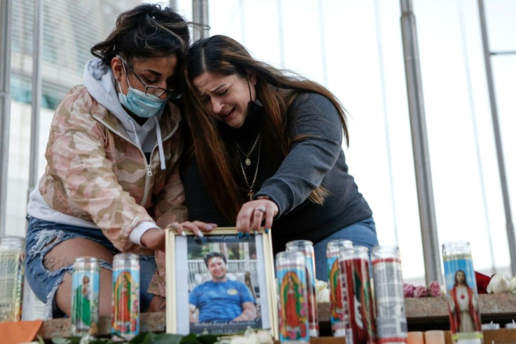 Christina Gonzalez and Alyssa Rubino mourn the death of their cousin, Michael Joseph Rudometkin, at a vigil for victims of the California rail yard shooting on May 27, 2021