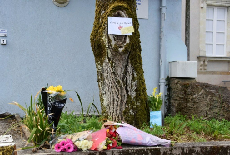 Flowers laid at the spot where a policewoman was stabbed in La Chapelle-sur-Erdre near the western city of Nantes on Friday