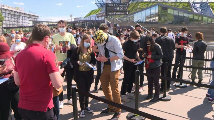 IMAGES People arrive to attend a test concert of French rock band Indochine and French DJ Etienne de Crecy, aimed at investigating how such events can take place safely amidst the Covid-19 pandemic at the AccorHotels Arena in Paris.