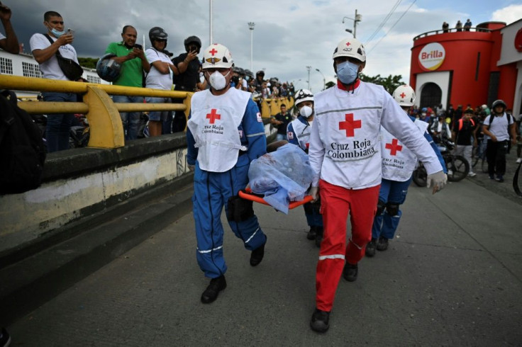 Rescue workers in the city of Cali on May 28 carry a corpse on a stretcher as protests against the Colombian government entered a second month