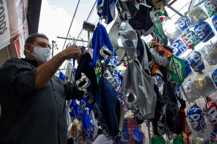 A seller arranges wrestling masks for sale outside the Arena Mexico in Mexico City; the return of pro wrestling has been a boon for nearby businesses