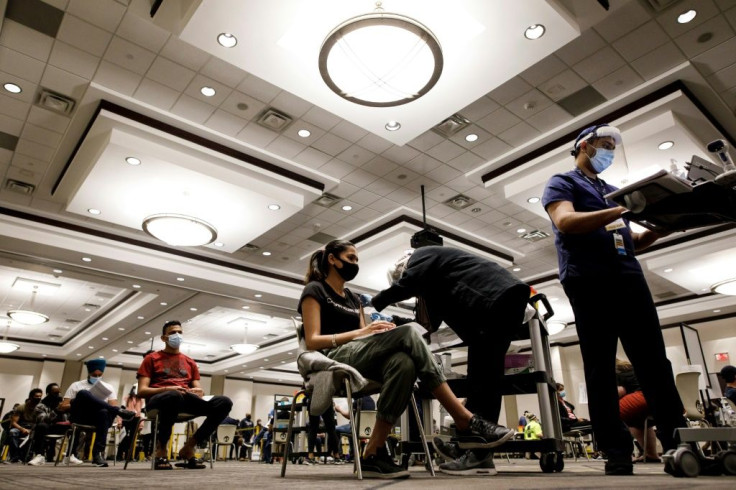 People receive their Covid-19 shot during a "Doses After Dark" overnight vaccination clinic in Mississauga, Ontario on May 15, 2021