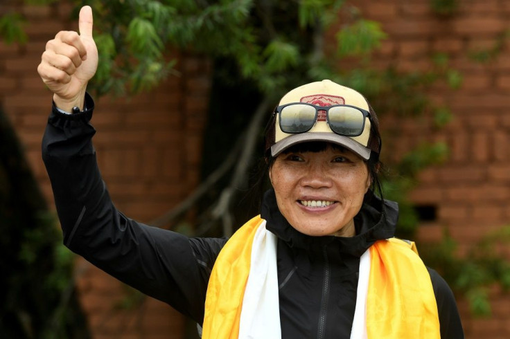 Former Hong Kong schoolteacher Tsang Yin-hung set a new record for the fastest ascent of Mount Everest by a woman in 25 hours and 50 minutes