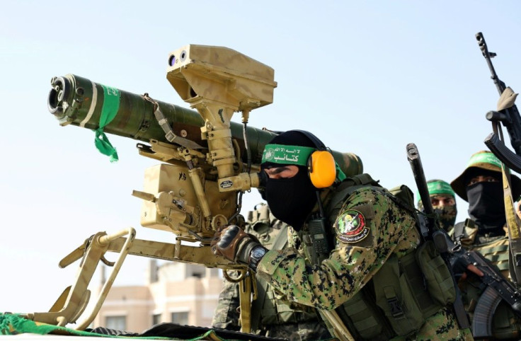 Members of the Ezz-Al Din Al-Qassam Brigades, the armed wing of the Palestinian Hamas movement, parade with an anti-tank weapon in Rafah in the southern Gaza Strip on May 28