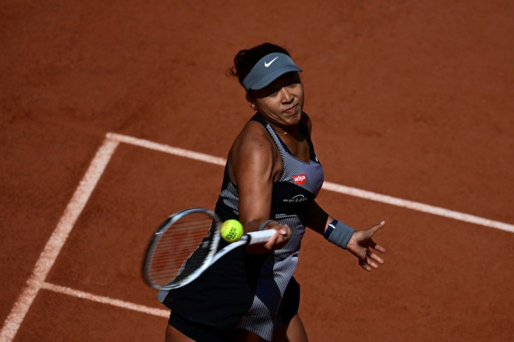 Into second round: Naomi Osaka returns the ball to Romania's Patricia Maria Tig