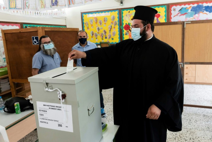 A Greek-Cypriot priest cast his ballot at a polling station in Nicosia on May 30, 2021 for parliamentary elections