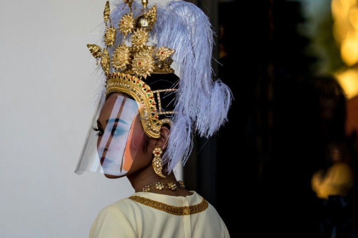 Traditional Thai dancers wore plastic face shields during an event to mark the return of two ancient sandstone lintels