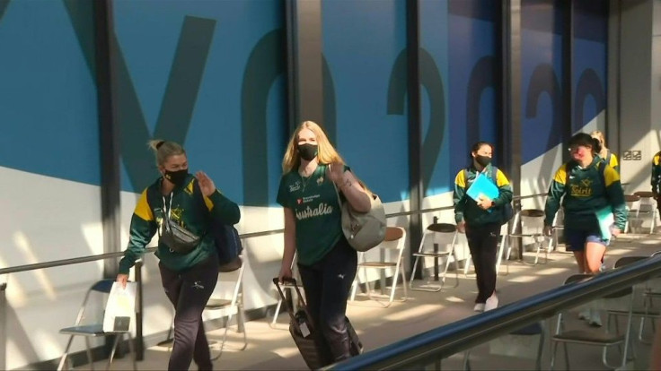 Members of the Australian softball team arrive at Narita airport outside Tokyo along with their support staff, becoming the first athletes to land in Japan for the Olympics.