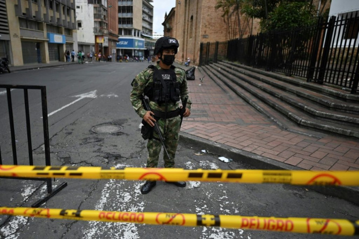 A Colombian soldier guards a road in Cali following a month of anti-government protests