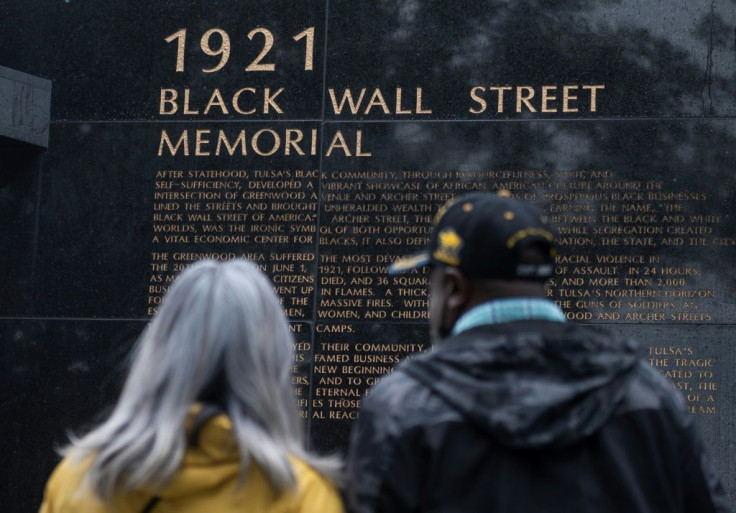 People look at the Black Wall Street Memorial on the 100-year anniversary of the Greenwood race massacre in Tulsa, Oklahoma