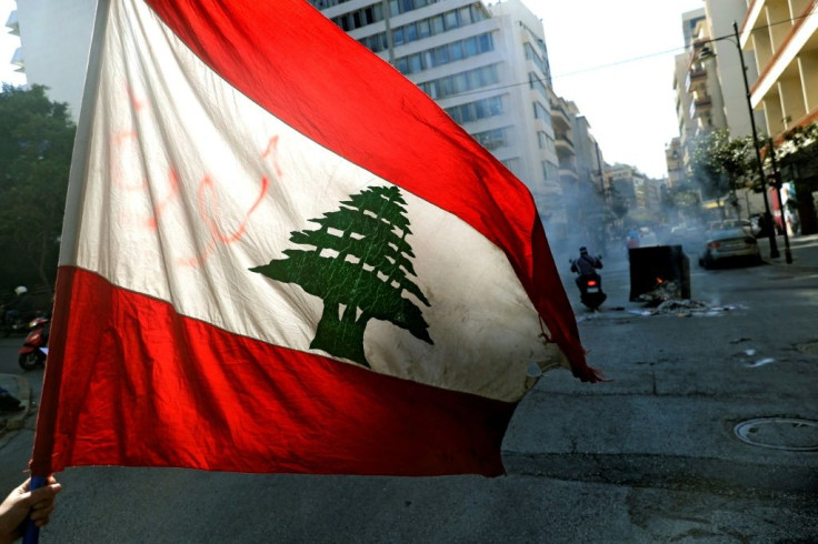 Anti-government demonstrators block the street with burning garbage dumpsters in front of Lebanon's central bank in this file picture taken on March 16, 2021