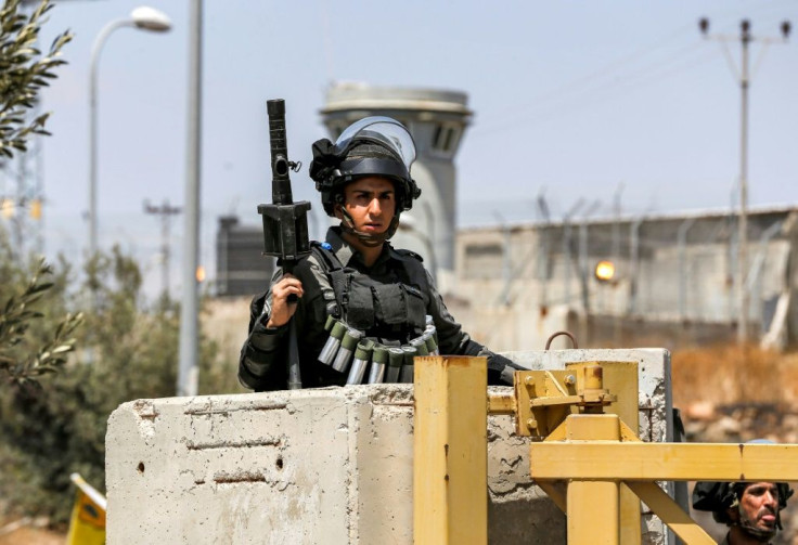 An Israeli border guard at a closed checkpoint leading to the Palestinian village of Nilin west of Ramallah in the occupied West Bank, amid a protest on May 29 against Israeli settlers' seizure of lands in the area