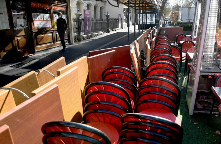 Tables and chairs are stacked up on the Lygon Street cafe and restaurant strip in Melbourne