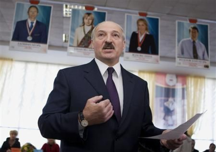 Belarussian President Alexander Lukashenko speaks to the media at a polling station during local election in Minsk