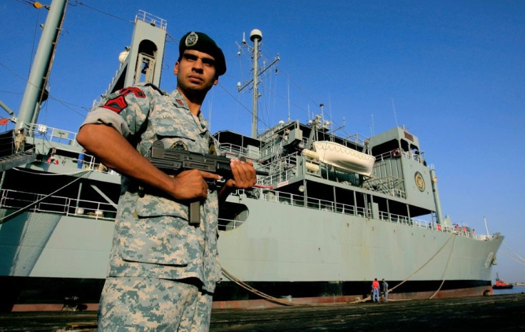 A member of Iran's special forces stands guard on the dock alongside the Kharg during a port call in Sudan in October 2012