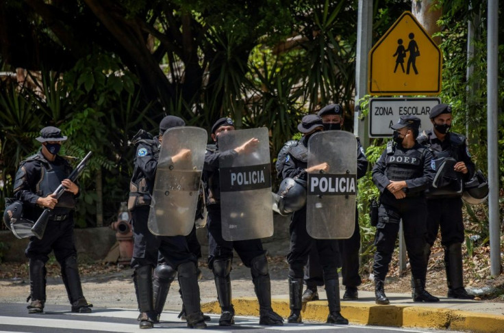 Riot police stand guard outside the house of Nicaraguan opposition leader Cristiana Chamorro