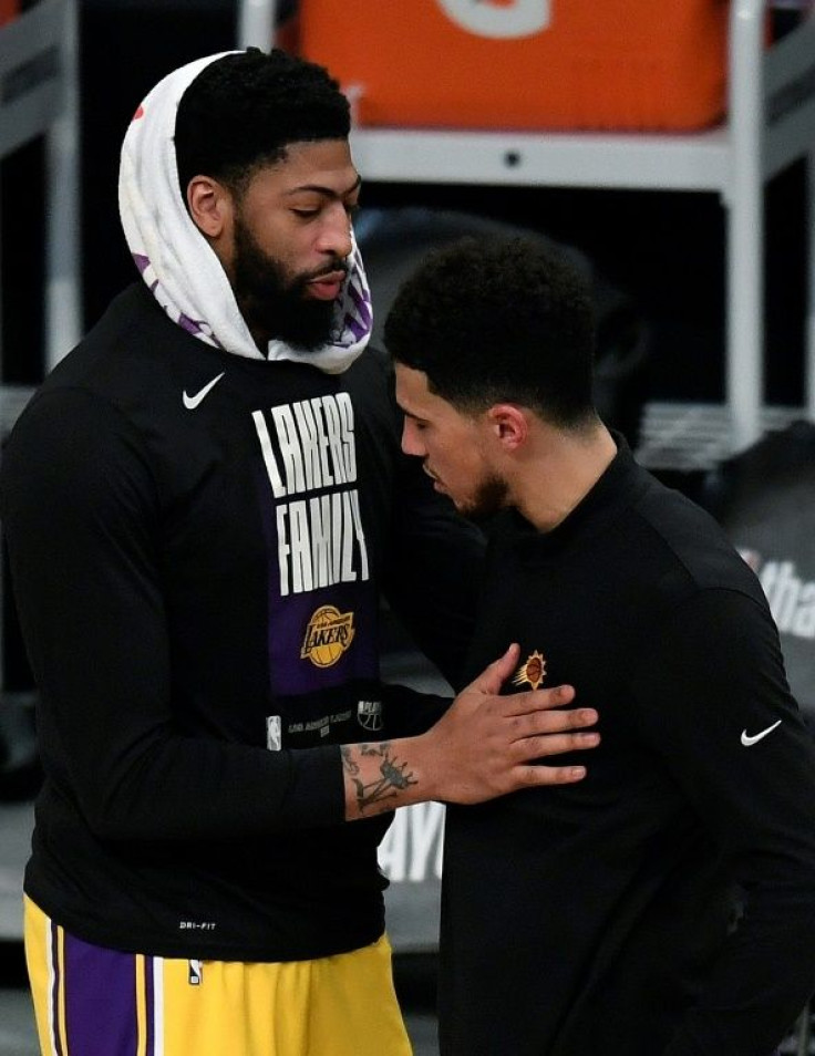 Anthony Davis of the Los Angeles Lakers shakes hands with Devin Booker of Phoenix after the Suns eliminated the Lakers from the NBA playoffs with a 113-100 victory