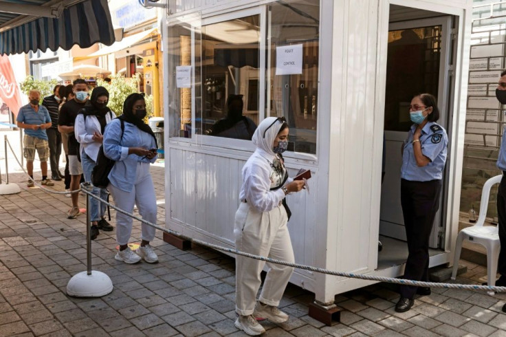 Pedestrians pass through the reopened Ledra Street crossing in the heart of Cyprus's divided capital Nicosia