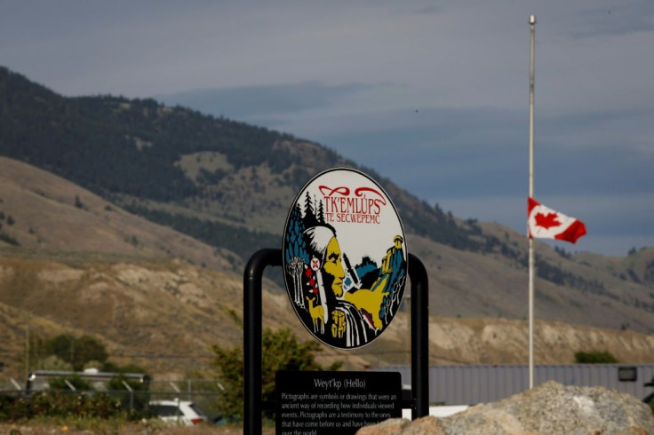 A Canadian flag hangs at half-mast at the Tkâemlups RCMP detachment near the former Kamloops Indian Residential School, where the remains of 215 children were found