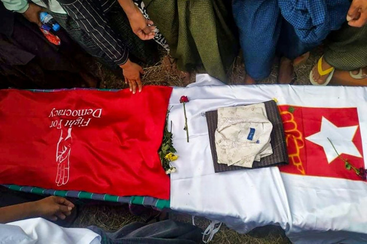 Mourners stand around the coffin of Khet Thi, who along with other poets in Myanmar dared to speak out against February's military coup