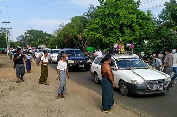 Mourners walk with the funeral procession for poet Khet Thi