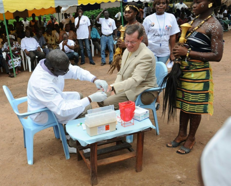 Then US health secretary Michael O.Leavitt (C) is given an AIDS-test in the village of Lomibo in Ivory Coast during a 2008 visit to organsations fighting HIV AIDS