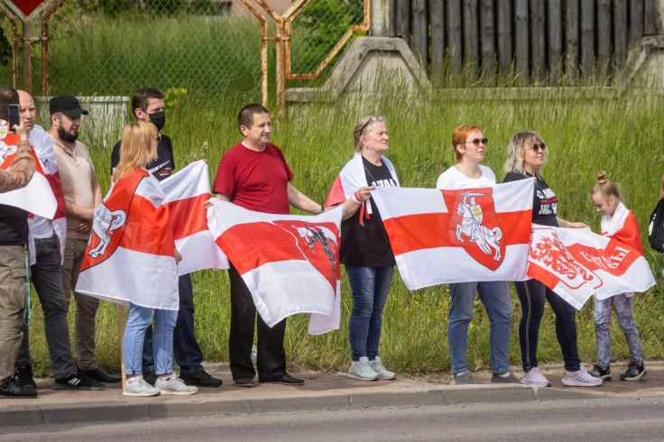 The Belarusian activists held red-and-white opposition flags