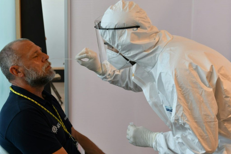 A crew member of the MSC Orchestra cruise ship undergoes a swab test