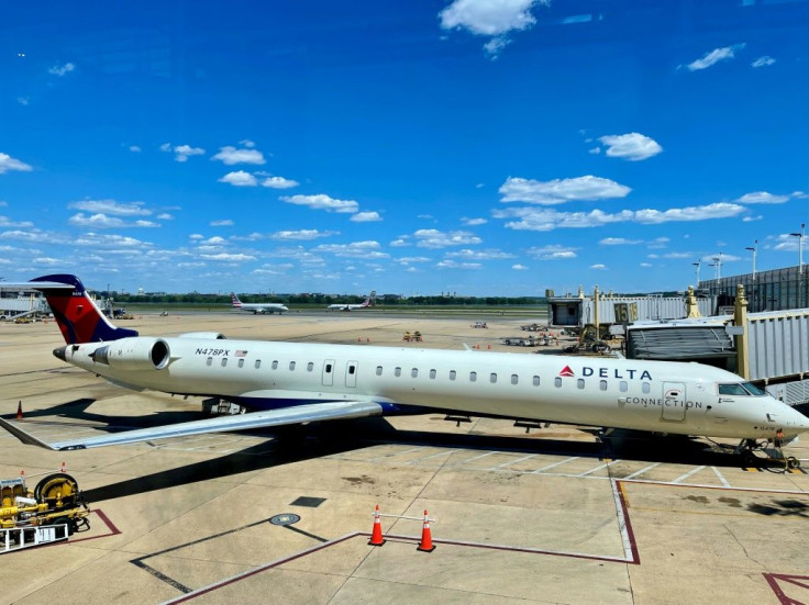 A Delta connection Bombardier CRJ-900 is seen at the gate at Ronald Reagan Washington National Airport (DCA) in Arlington, Vi rginia in May 2021; A passenger on a US Delta jet tried to smash his way into the cockpit