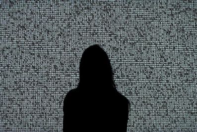 A woman looks at an NFT by Ryoji Ikeda titled 'A Single Number That Has 10,000,086 Digits' during a media preview at Sotheby's in New York ahead of an NFT auction June 10, 2021