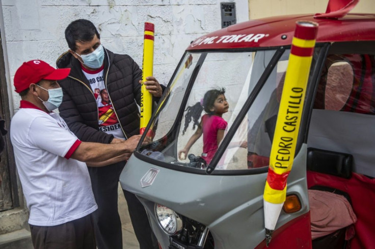 Supporters of the Peruvian left-wing presidential candidate for Peru Libre party, Pedro Castillo, display pencils, the symbol of the party, ahead of the runoff presidential election of June 6 between right-wing Keiko Fujimori and Castillo