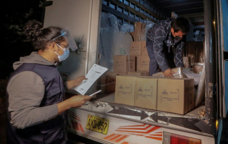 Workers distribute electoral material in voting centers in Callao, near Lima on June 5, 2021 ahead of the runoff presidential election