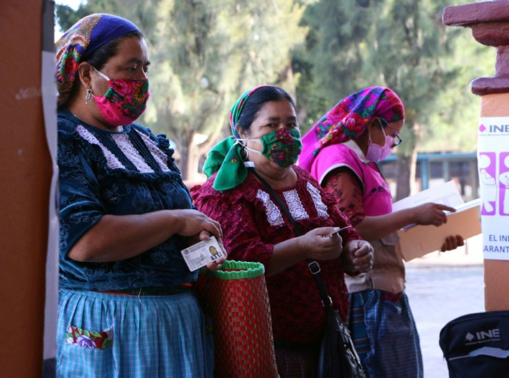 Mexicans wait to cast their votes in San Bartolome Quialana in the southern state of Oaxaca