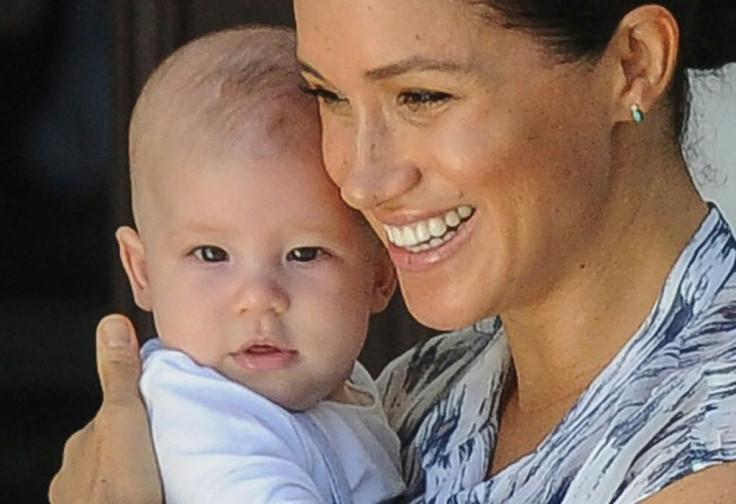 (FILES) In this file photo  Meghan, Duchess of Sussex holds her baby son Archie as she and Britain's Prince Harry, Duke of Sussex meet Archbishop Desmond Tutu and his wife Leah at the Tutu foundation in Cape Town. Prince Harry and Meghan Markle announced 