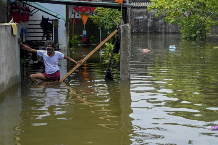 A resident stands in floodwaters after heavy monsoon rains in Kelaniya