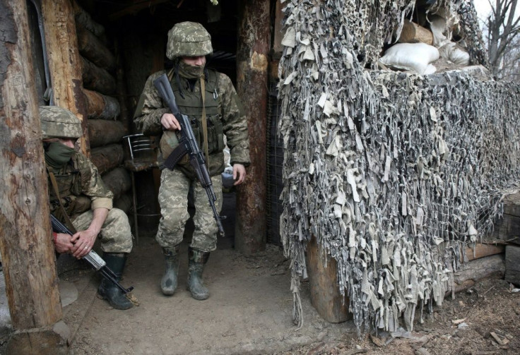 Ukrainian servicemen wait at a position on the frontline with Russia-backed separatists near Gorlivka, Donetsk region