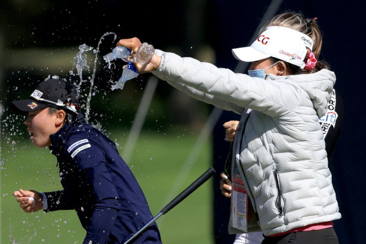Yuka Saso (L) was doused with water after winning the 76th US Women's Open